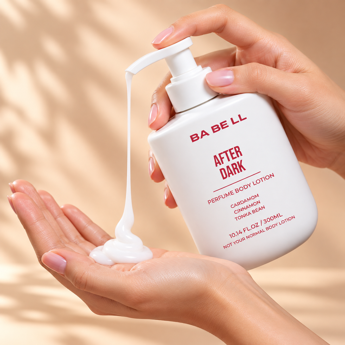 Babell After Dark perfume body lotion pump dispensing white lotion into a palm