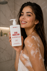 Woman in the shower holding Babell Skin Addiction perfume body wash, 250ml.