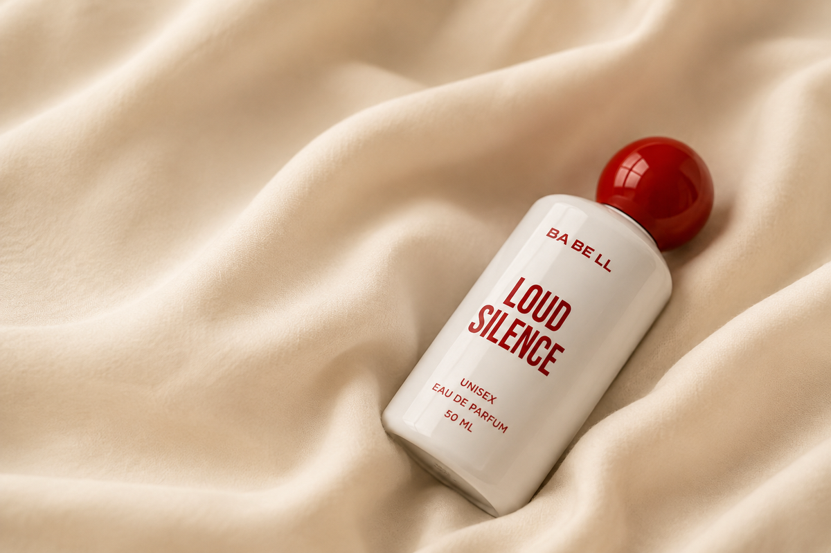 A Babell Loud Silence eau de parfum bottle resting on folds of cream silk