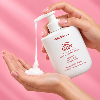 Babell Loud Silence perfume body lotion pump dispensing white lotion into a palm