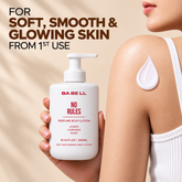 Woman holding Babell No Rules perfume body lotion beside a drop of lotion on her shoulder
