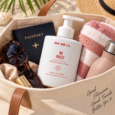 Babell No Rules perfume body lotion 300ml bottle in a travel bag beside a passport and towel